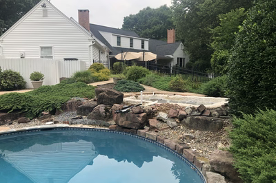 Hemlock E - East Petersburg, PA - A backyard with a pool and landscaping around it.