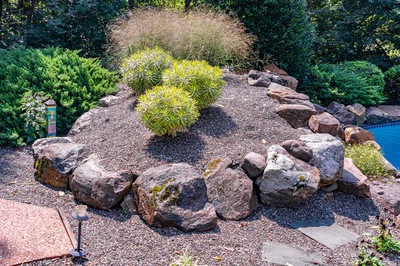 Hemlock K - East Petersburg, PA - A rock garden with shrubs and a swimming pool in the background