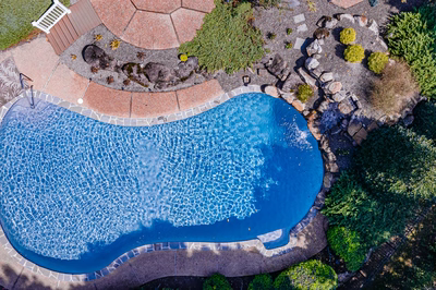 Hemlock O - East Petersburg, PA - A bird's eye view of a swimming pool surrounded by greenery and rocks