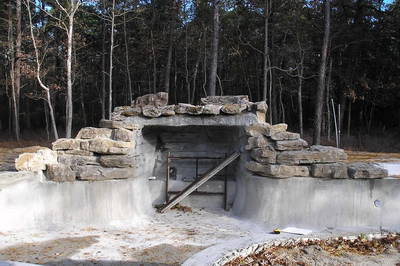 Horseshoe A - Galloway, NJ - A small stone structure in the middle of a forest, surrounded by trees