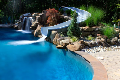 Horseshoe D - Galloway, NJ - A swimming pool with a waterfall and a slide in the middle of it