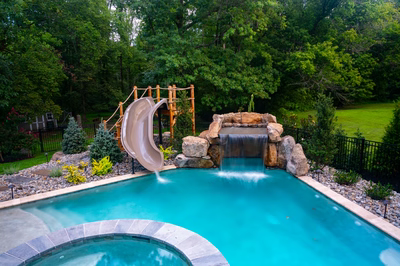 Horsetail A - Marlton, NJ - A swimming pool with a waterfall and a slide in a backyard setting