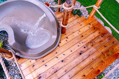 Horsetail K - Marlton, NJ - A wooden deck with rope railing and a metal bowl filled with water.
