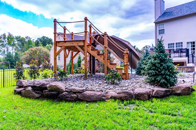 Horsetail L - Marlton, NJ - A wooden play structure with a slide in a backyard setting.