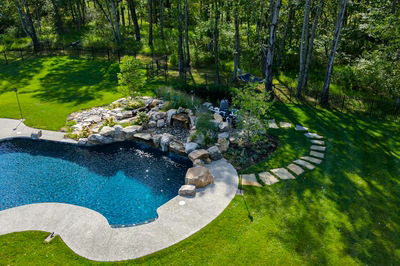 Howick N - Ivyland, PA - A backyard with a swimming pool surrounded by lush green grass and trees