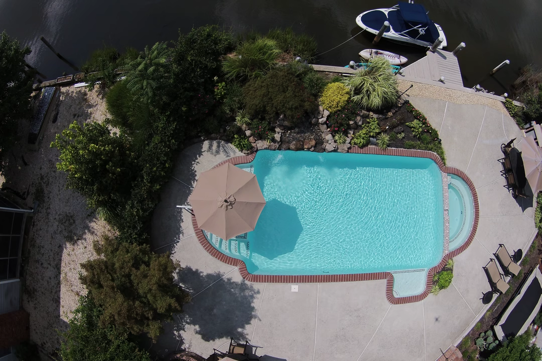 Hoy E - Point Pleasant, NJ - A bird's eye view of a swimming pool surrounded by lush greenery and umbrellas