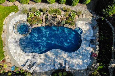 Huka I - Moorestown, NJ - A bird's eye view of a swimming pool surrounded by lush greenery and flowers