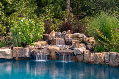 Jodo B - Medford, NJ - A natural pool with a waterfall surrounded by lush greenery and flowers