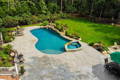 Jodo I - Medford, NJ - A backyard with a swimming pool surrounded by lush green grass and trees