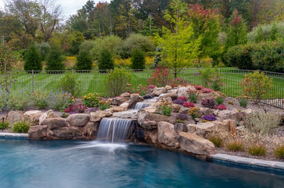 Juba C - Flemington, NJ - A beautiful backyard with a waterfall surrounded by colorful flowers and greenery