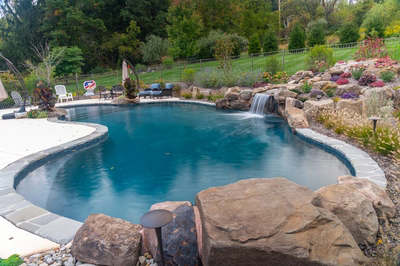 Juba D - Flemington, NJ - A swimming pool with a waterfall surrounded by rocks and plants
