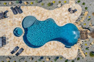 Kamui L - Phoenix, MD - A bird's eye view of a swimming pool surrounded by a stone patio and landscaping