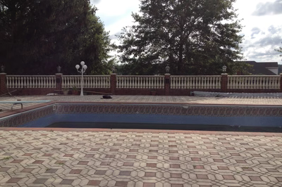 Kander A - Holmdel, NJ - A brick pool deck with a decorative fence around it.