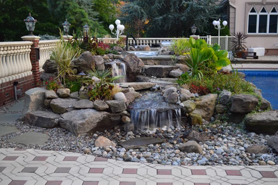 Kander E - Holmdel, NJ - A small waterfall in a rock garden next to a swimming pool