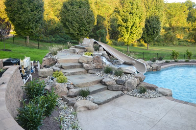 Kedron D - Thorton, PA - A backyard with a pool and a water feature with a slide