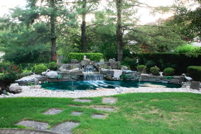 Kegon B - Cherry Hill, NJ - A garden with a pond and a waterfall surrounded by lush greenery