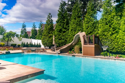 Lamberson D - Mount Laurel, NJ - A swimming pool with a slide and a basketball hoop in a backyard setting