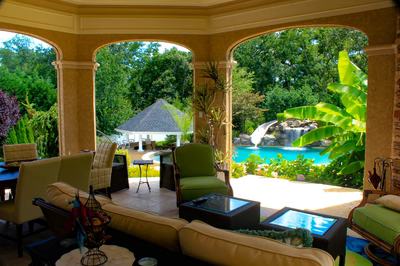 Linton D - Galloway, NJ - A living room filled with furniture and a view of a pool and waterfall.