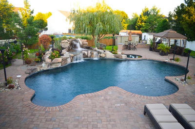 Lisbon A - Marlton, NJ - A backyard with a swimming pool and a waterfall.