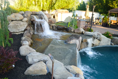Lisbon C - Marlton, NJ - A backyard with a pool and a waterfall feature.