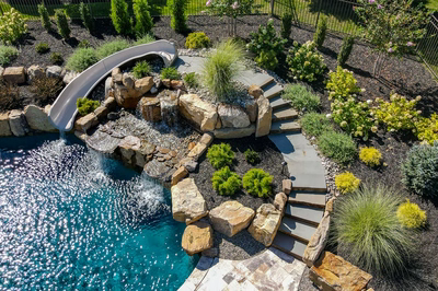 M Brown - Forrest Hills, MD - A backyard with a swimming pool and a water feature with a slide