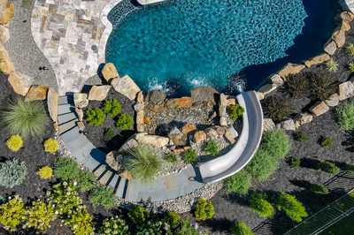 M Brown - Forrest Hills, MD - A bird's eye view of a backyard with a swimming pool and a water feature