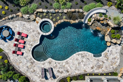 M Brown - Forrest Hills, MD - A bird's eye view of a swimming pool surrounded by lush greenery and landscaping