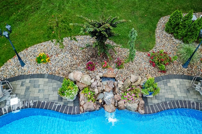 Manido H - Matawan, NJ - A bird's eye view of a backyard with a swimming pool and a waterfall