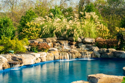Morris W - New Hope, PA - A natural swimming pool surrounded by lush greenery and rocks with a waterfall