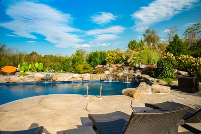 Morris W - New Hope, PA - A beautiful outdoor swimming pool surrounded by lush greenery and a waterfall.