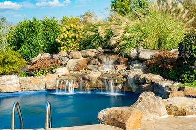 Morris W - New Hope, PA - A swimming pool surrounded by lush greenery and a waterfall.