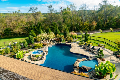 Morris W - New Hope, PA - A large backyard with a swimming pool surrounded by lush greenery and trees
