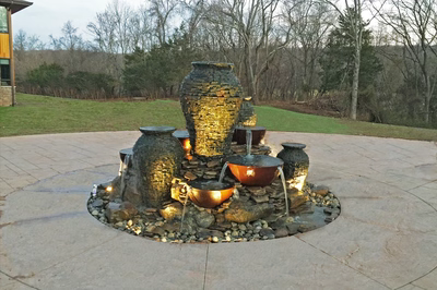 Maruyama - New Hope, PA - A stone fountain with three large vases and bowls on top of it.