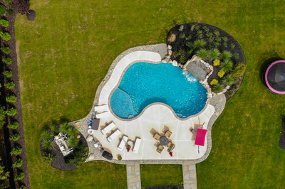 Masinga - Lumberton, NJ - A bird's eye view of a backyard with a swimming pool surrounded by lush greenery