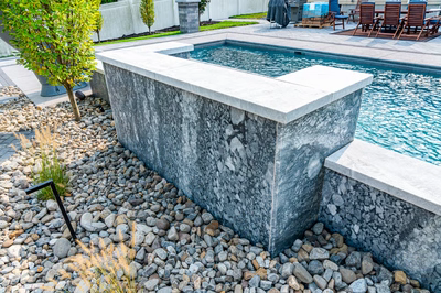 Memorial K - Cherry Hill, NJ - A modern backyard with a swimming pool surrounded by pebbles and landscaping