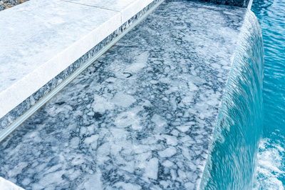 Memorial N - Cherry Hill, NJ - A close-up view of a blue pool with water flowing out of it.