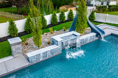 Memorial P - Cherry Hill, NJ - A swimming pool with a water feature and a slide in a backyard setting