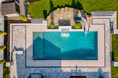 Memorial T - Cherry Hill, NJ - A bird's eye view of a swimming pool surrounded by lush green grass and stone features