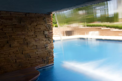 Middle E - Millstone, NJ - A long exposure shot of a swimming pool with a waterfall in the background