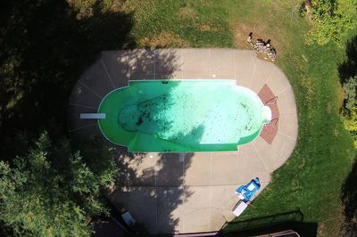 Mist A - Marlboro, NJ - A bird's eye view of an above ground swimming pool surrounded by greenery