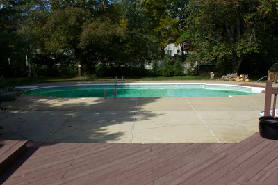 Mist C - Marlboro, NJ - A rectangular swimming pool surrounded by trees and a wooden deck.