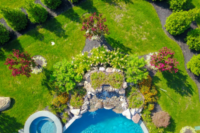 Moran C - Millstone, NJ - A bird's eye view of a garden with a swimming pool surrounded by lush greenery and flowers