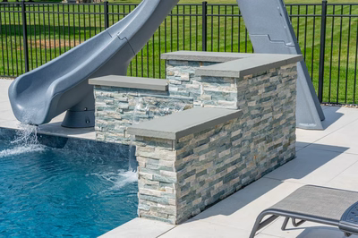 Mossbrae E - Millstone, NJ - A pool with a water feature and a slide in a backyard setting