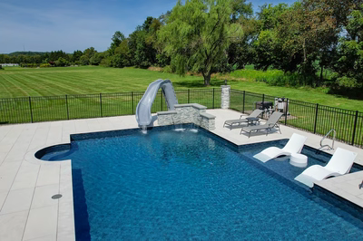 Mossbrae N - Millstone, NJ - A large backyard with a swimming pool and a water feature, surrounded by lush green grass and trees