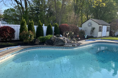 Multnomah A - West Deptford, NJ - A backyard with a swimming pool surrounded by trees and shrubs