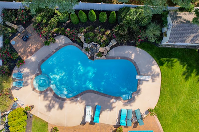 Multnomah K - West Deptford, NJ - A bird's eye view of a swimming pool surrounded by lush greenery and flowers
