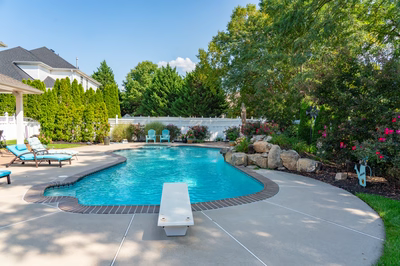 Multnomah L - West Deptford, NJ - A backyard with a swimming pool surrounded by lush greenery and flowers