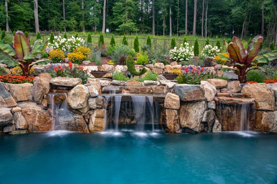 Munising B - Randolph, NJ - A beautiful garden with a waterfall and colorful flowers surrounding a pool