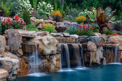 Munising F - Randolph, NJ - A beautiful garden with a waterfall surrounded by colorful flowers and rocks