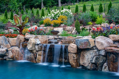 Munising I - Randolph, NJ - A beautiful garden with a waterfall surrounded by colorful flowers and rocks